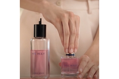 Image Hands are closing a perfume bottle because she refilled it.
